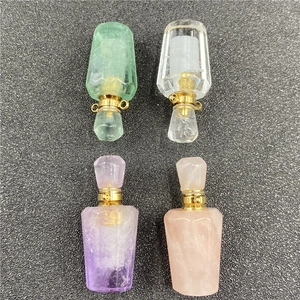 Macro view of four faceted crystal perfume bottle pendants in varied pastel gemstones