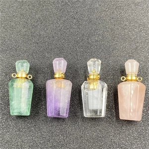 Detailed macro view of multifaceted crystal perfume bottles in four distinct gemstone colors