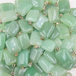 Bulk display of polished light green rectangular stone pendants with silver metal clasps