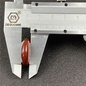 Macro shot of a red agate bead measured with a caliper showing 8.8mm thickness