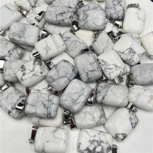 Macro view of rectangular white turquoise stone pendants with grey marble texture and silver bails
