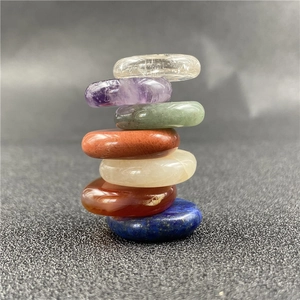 Vertical stack of seven polished oval natural chakra balancing healing energy stones