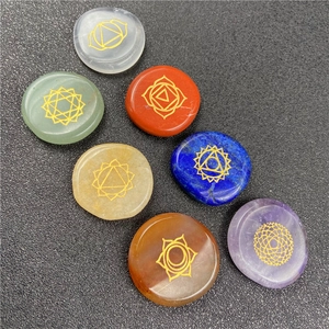 Set of 7 chakra natural stones with golden engraved symbols on smooth oval healing crystals