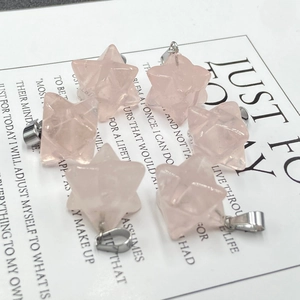 Close-up of pink quartz Merkaba star pendants with polished facets and silver bails