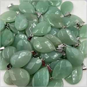 Bulk display of faceted light green teardrop pendants with silver-colored metal clasps