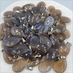Pile of faceted water drop agate pendants with polished grey striped stone and silver bails
