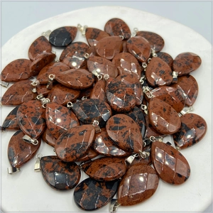 Detailed view of faceted and smooth mahogany obsidian water drop stone pendants
