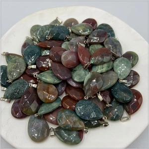 Macro view of teardrop faceted crystal pendants in various natural stones with metal loops
