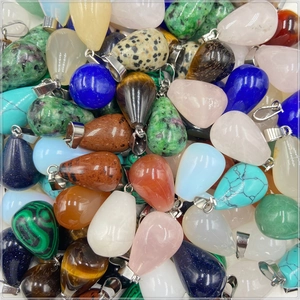 Detailed view of teardrop crystal pendants in agate, rose quartz and mixed gemstones