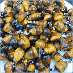 Macro view of teardrop tiger eye stone pendants with polished texture and silver bails