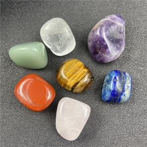 Detailed view of seven polished natural crystal tumble stones for meditation and healing