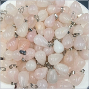 Close-up of translucent teardrop quartz pendants with natural textures and silver bails