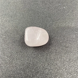 Close-up of polished natural rose quartz stone with smooth surface and translucent pink hue