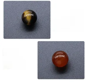 Detailed macro view of Tiger Eye and Red Agate crystal spheres for sacral and root chakras