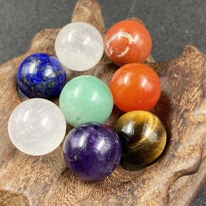 Set of 8 polished natural crystal spheres including rose quartz and amethyst with wood base