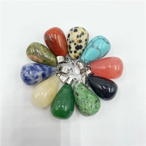 Detailed macro view of assorted natural crystal teardrop pendants with silver metal clasps