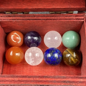 Set of 8 polished 16mm natural stone spheres displayed in a wooden collection box