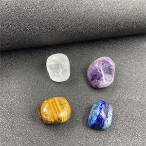 Polished natural crystals including Amethyst and Tiger Eye on textured background