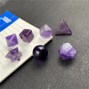 Close-up of seven purple amethyst geometric polyhedrons for teaching and decoration