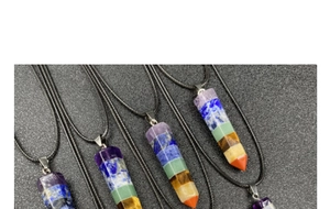 Macro detail of seven-layer chakra hexagonal crystal prism pendants with black cords