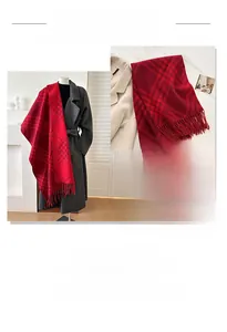 Detailed view of red plaid winter scarf with long tassels and soft thick cashmere texture
