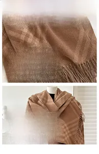 Detail of soft brown plaid cashmere-feel scarf with handmade tassel edges and vintage pattern