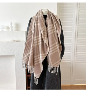 Detail of khaki plaid cashmere scarf with soft tassels and high-quality fabric texture