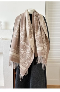 Close-up of vintage jacquard scarf with retro fringe detail in earth tones