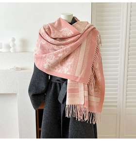 Detail view of pink and beige cashmere-feel scarf with intricate floral jacquard and long tassels