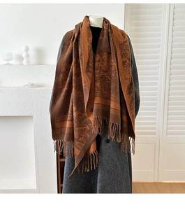 Detail of vintage jacquard scarf with fringe trim paired with wool coat and tassels