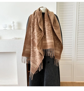 Close-up of jacquard forest pattern and tassels on earth-tone cashmere-feel scarf
