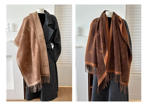 Detailed close-up of reversible scarf with cat jacquard patterns and soft tassel edges