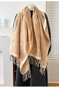 Detailed close-up of thick jacquard cat pattern scarf with soft fringe and knit texture