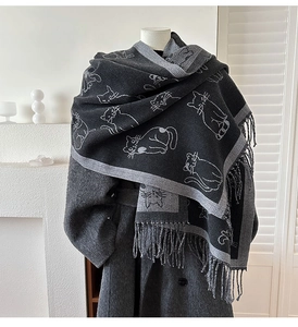 Close-up of double-sided jacquard cat pattern and long tassels on thick cashmere-like scarf