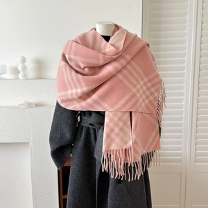 Pink and beige plaid cashmere-feel winter scarf with fringes on a grey wool coat
