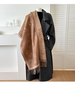 Detail of double-sided jacquard cat pattern scarf with fringe on wool coat