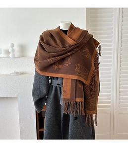 Detail of cute cat jacquard pattern on thick caramel cashmere-like winter scarf with fringes
