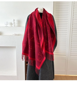 Detailed view of the dark red cashmere-like scarf with knitted cat patterns and long tassels