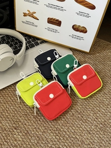Detailed overhead view of colorful mini canvas pouches with zippers and climbing hooks