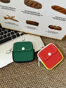 Detail of mini canvas coin purses with snap pockets and metal climbing hooks on top