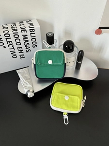Mini canvas storage pouches in green and lime with white snap pockets and plastic hooks