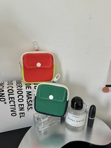 Mini canvas coin pouches with metal hooks shown alongside lifestyle fashion accessories
