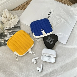 Quilted mini headphone storage pouches in yellow and blue with zippers and spring hooks