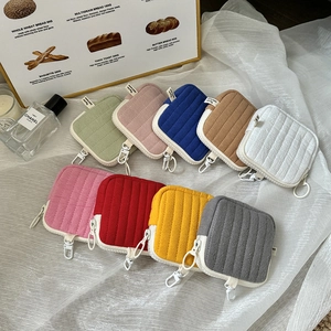 Detailed view of quilted mini storage pouches in various colors with hanging hooks