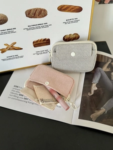 Detailed view of mesh mini storage pouches with zipper and button pocket for lipsticks