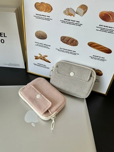 Detailed shot of canvas mini pouches for earbuds and data cables on a laptop