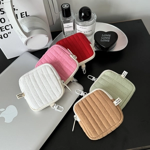 Quilted mini earphone case and coin pouch with hook shown in five assorted pastel colors