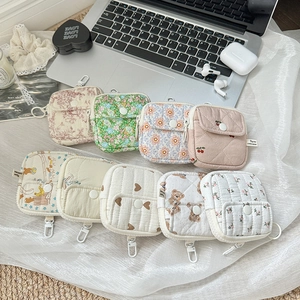 Detailed display of assorted floral and cherry quilted mini pouches with hanging clips