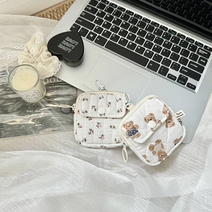 Detailed view of quilted cotton mini pouches with floral and bear prints and hooks