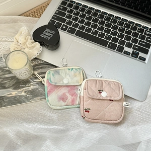 Quilted cotton mini storage bags with cherry print and carabiner on a lifestyle desk setup